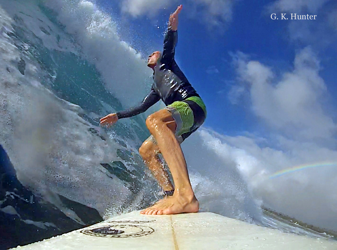 Author G. K. Hunter surfing a big wave in Haleiwa, Oahu, Hawaii